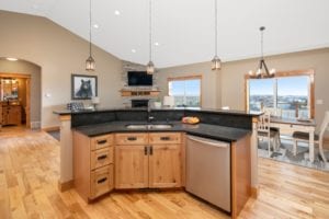 Luxury Kitchen and open floor plan with wood cabinets and trim in a new construction of a single family home in Billings MT, a Safe and Secure New Community