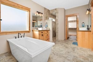 Free-standing tub in a Luxury Bathroom with wood trim in a new construction of a single family home in Billings MT, a Safe and Secure New Community